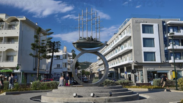 Modern sculpture in an urban setting with surrounding modern buildings, Sculpture The Traveller, Kos Town, Kos, Dodecanese, Greek Islands, Greece
