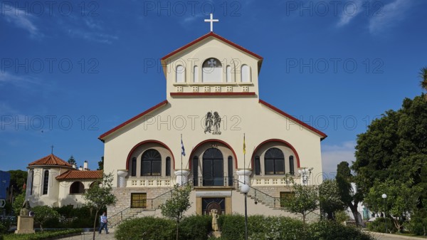 Frontal view of a church with a cross in front of a blue sky, Kos Cathedral, Kos Town, Kos, Dodecanese, Greek Islands, Greece