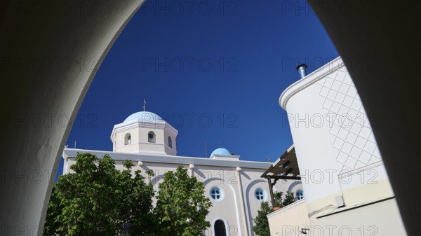 View of a sacred church with dome through an arch under a clear sky, Agia Paraskevi Church, Kos Town, Kos, Dodecanese, Greek Islands, Greece