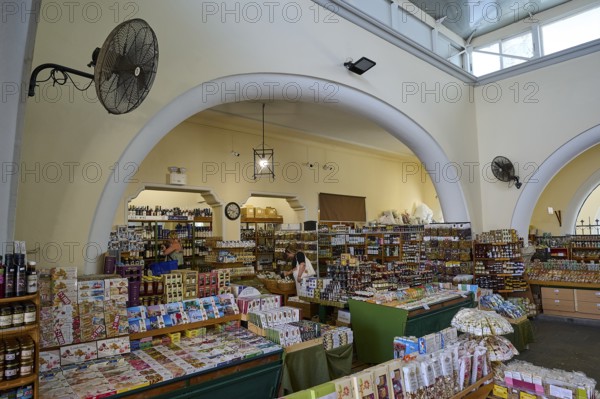 Bright market interior with shelves full of products and large arches, market hall, Agora, Kos Town, Kos, Dodecanese, Greek Islands, Greece