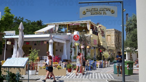 Lively street scene with people at a café in sunny weather, Platia Diagora, Kos Town, Kos, Dodecanese, Greek Islands, Greece