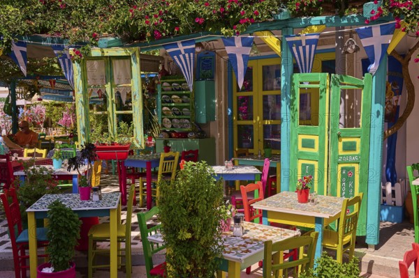 Colourfully decorated taverna with open doors and plants, summery and friendly atmosphere, Platia Diagora, Kos Town, Kos, Dodecanese, Greek Islands, Greece