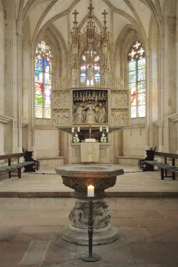 High altar and baptismal font of the Romanesque St. Mary's Church, interior view, colourful church windows, winged altar, folding altar, arts and crafts, decorations, candlesticks, Freyburg, Romanesque Road, Saxony-Anhalt, Germany