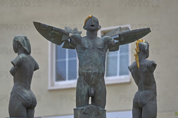 Market fountain with sculptures by Christof Traub 1995, three symbols fire, water and wind, torso, naked, golden stripes, male figure, wings, modern art, market square, Gräfenhainichen, Saxony-Anhalt, Germany