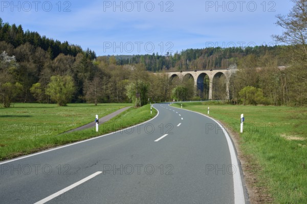 A winding road leads to a viaduct in a wooded landscape, spring, Obersinn, Sinntal, Spessart, Bavaria, Germany