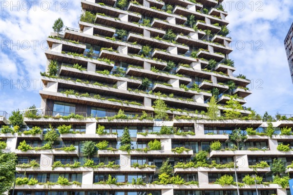 Wonderwoods residential tower, one of 2 green buildings, in Utrecht in the new Healthy Urban Quarter, at the central station, 105 metres high with 30 floors, Tower II, over 360 trees and over 9600 shrubs and flowering plants native to the region, all irrigated with collected rainwater, sponge city principle and monitored with sensors, Utrecht, Netherlands