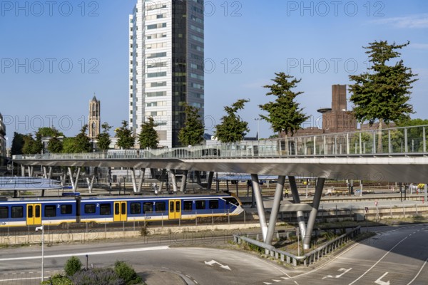 The Moreelsebrug, pedestrian and cycle bridge over the tracks of Utrecht Centraal, Central Station, Greened with trees, Netherlands