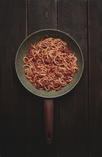 Spaghetti bolognese, in a frying pan, top view, homemade, no people