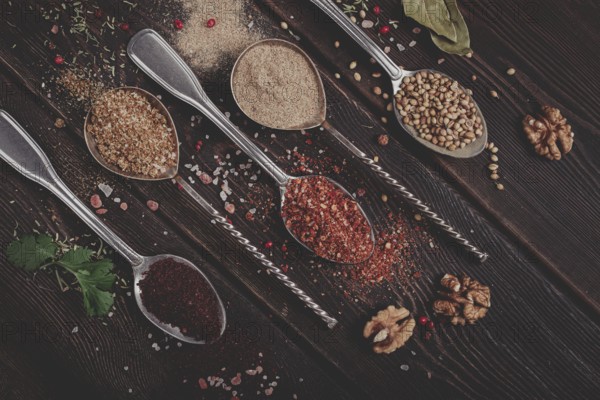 Georgian spices in spoons, on a wooden background, top view, no people