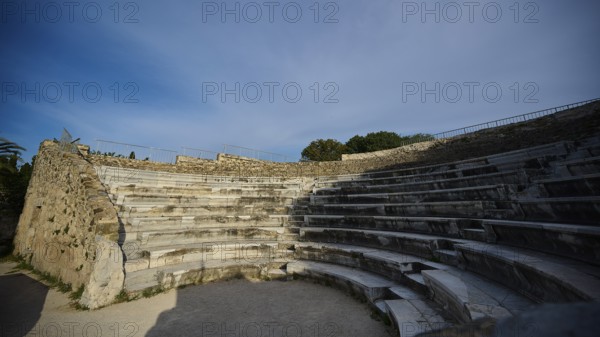 ©Udo Rein, Old amphitheatre with rows of stone seats under a clear sky, historical atmosphere, Ancient Theatre, Kos Town, Kos, Dodecanese, Greek Islands, Greece