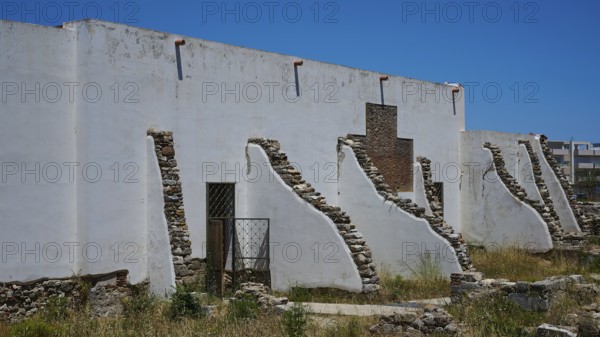 ©Udo Rein, White antique building with exposed stone walls under a blue sky, exterior view, Casa Romana, Kos Town, Kos, Dodecanese, Greek Islands, Greece