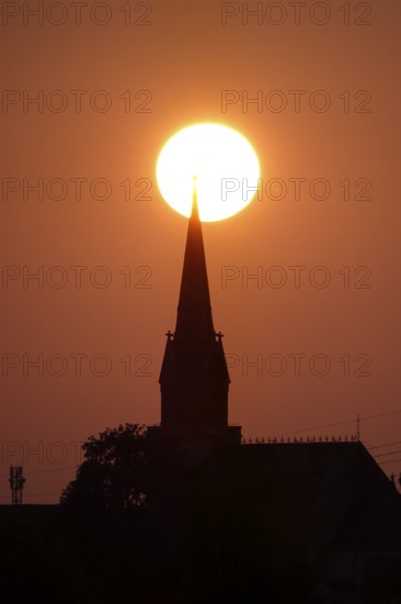 Sun in the evening in June, church tower, Germany
