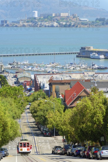 Powell-Hyde line cable car with Alcatraz Island in the background, San Francisco, California, USA
