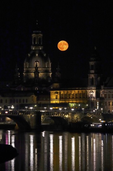 Glowing strawberry moon on 11 June 2025 next to the Church of Our Lady Dresden, Saxony, Germany