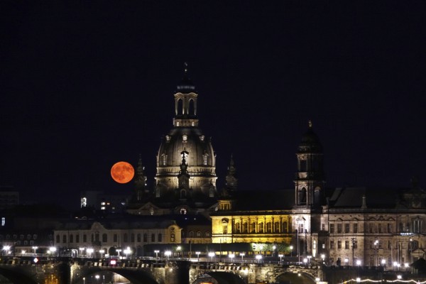 Glowing strawberry moon on 11 June 2025 over Augustus Bridge and Church of Our Lady Dresden, Saxony, Germany