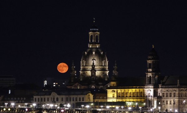 Glowing strawberry moon on 11 June 2025 over the Church of Our Lady Dresden, Saxony, Germany
