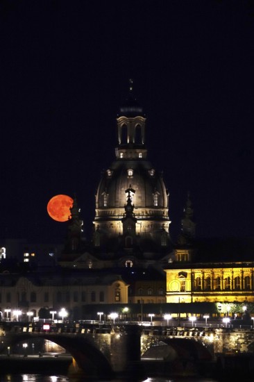 Glowing strawberry moon on 11 June 2025 over the Church of Our Lady Dresden, Saxony, Germany