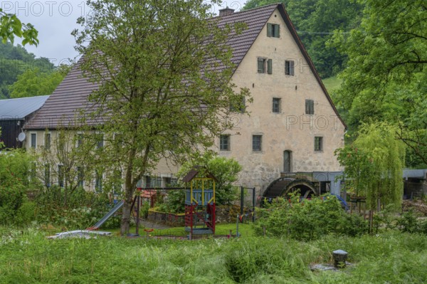 Former corn mill with water wheel, Großenohe, Upper Franconia, Bavaria, Germany