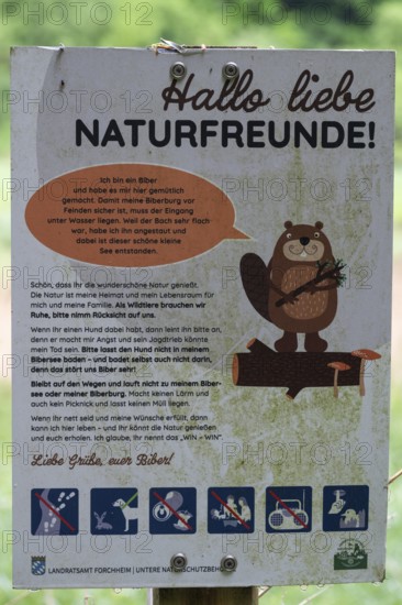 Information board at a stream dammed by beavers, Großenohe, Upper Franconia, Bavaria, Germany