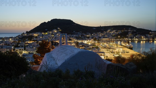 Chapel Agia Paraskevi, town with harbour at dusk, illuminated, hill in the background, Skala, harbour, cruise ship, Patmos, Dodecanese, Greek Islands, Greece