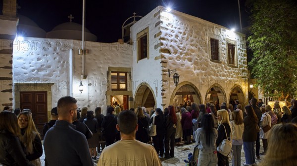 Church of Agios Ioannis Prodromos, Maundy Thursday, Megali Pempti, worshippers, people gather at night in front of an illuminated church, Skala, harbour, Patmos, Dodecanese, Greek Islands, Greece