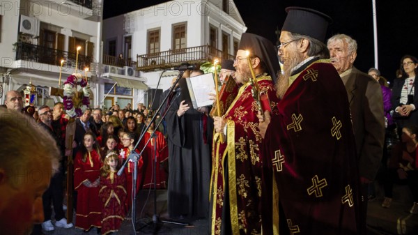 Good Friday, Epitaphios, funeral procession, priest in traditional traditional costume speaking during a night procession, Skala, harbour, Patmos, Dodecanese, Greek Islands, Greece