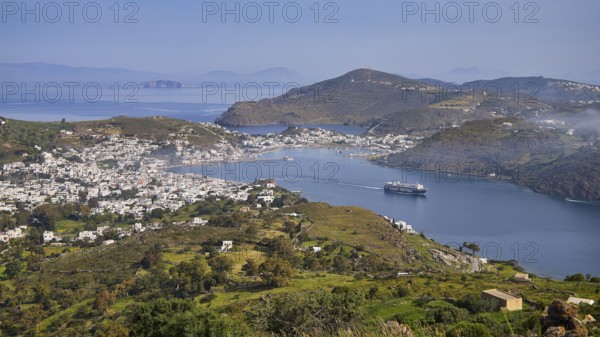 Panoramic view of a bay with town, ferry and surrounding landscape, Skala, harbour, Patmos, Dodecanese, Greek Islands, Greece