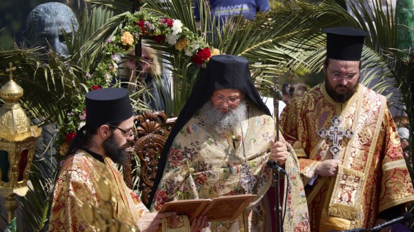 Priests in richly decorated robes reading from a book during a solemn ceremony under palm trees, Orthodox ceremony, monks of St John's Monastery, ceremonial washing of feet, procession, Maundy Thursday, Megali Pempti, Chora, Patmos, Dodecanese, Greek Islands, Greece