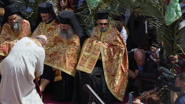 Priests in golden robes perform a religious ritual in front of a gathered crowd, Orthodox ceremony, monks of St John's Monastery, ceremonial washing of feet, procession, Maundy Thursday, Megali Pempti, Chora, Patmos, Dodecanese, Greek Islands, Greece