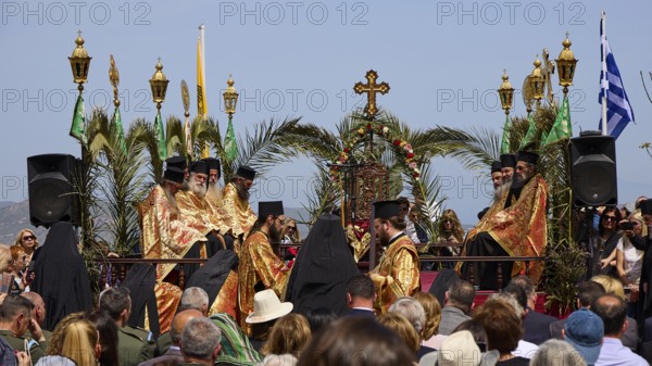 A procession of priests in golden robes, surrounded by palms and religious symbols, holds an outdoor ceremony, Orthodox ceremony, monks of St John's Monastery, ceremonial washing of feet, procession, Maundy Thursday, Megali Pempti, Chora, Patmos, Dodecanese, Greek Islands, Greece