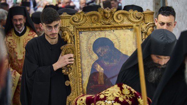 Men in black robes carrying an icon in a golden frame during a procession, Orthodox ceremony, monks of St John's Monastery, ceremonial washing of feet, procession, Maundy Thursday, Megali Pempti, Chora, Patmos, Dodecanese, Greek Islands, Greece