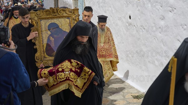 A priest in a black robe leads a procession while another carries an icon, Orthodox ceremony, monks of St John's Monastery, ceremonial washing of feet, procession, Maundy Thursday, Megali Pempti, Chora, Patmos, Dodecanese, Greek Islands, Greece