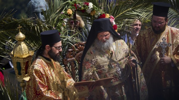 Priests in magnificent robes celebrate a religious ritual surrounded by palm trees and a festive atmosphere, Orthodox ceremony, monks of St John's Monastery, ceremonial washing of feet, procession, Maundy Thursday, Megali Pempti, Chora, Patmos, Dodecanese, Greek Islands, Greece