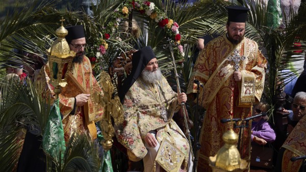 Priests in elaborate robes sit surrounded by palm trees during an outdoor religious ceremony, Orthodox ceremony, monks of St John's Monastery, ceremonial washing of feet, procession, Maundy Thursday, Megali Pempti, Chora, Patmos, Dodecanese, Greek Islands, Greece