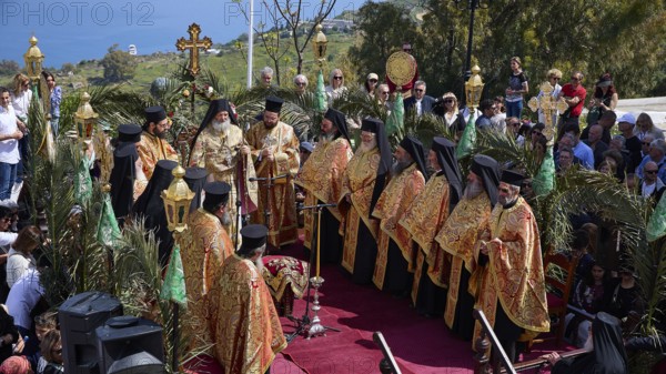 Solemn outdoor religious ceremony with Orthodox priests in gold-decorated robes, surrounded by people, Orthodox ceremony, monks of St John's Monastery, ceremonial washing of feet, procession, Maundy Thursday, Megali Pempti, Chora, Patmos, Dodecanese, Greek Islands, Greece