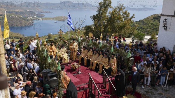 Crowd gathers on a hill overlooking the sea while priests perform a ceremony, Orthodox ceremony, monks of St John's Monastery, ceremonial washing of feet, procession, Maundy Thursday, Megali Pempti, Chora, Patmos, Dodecanese, Greek Islands, Greece