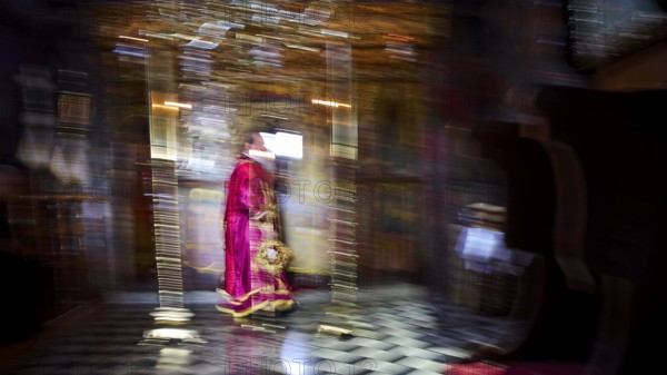 Zoodochou Pigis Monastery, Blurred image of a priest in red robes in a gold-decorated church interior, Church, Chora, World Heritage Site 1999, Patmos, Dodecanese, Greek Islands, Greece