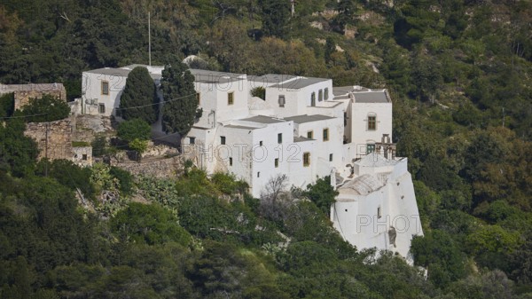 Monastery on a green hill with trees and surrounding nature, Monastery of the Revelation, Moni tis Apokalipsis, World Heritage Site 1999, Patmos, Dodecanese, Greek Islands, Greece