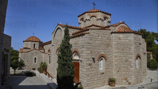 Large stone church building with several domes and a cross in the courtyard, woman's monastery, Evangelismou Monastery, Patmos, Dodecanese, Greek Islands, Greece