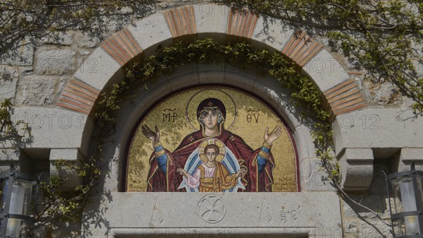 Mosaic above a door shows Mother of God with child, embedded in stone wall, woman's monastery, Evangelismou Monastery, Patmos, Dodecanese, Greek Islands, Greece
