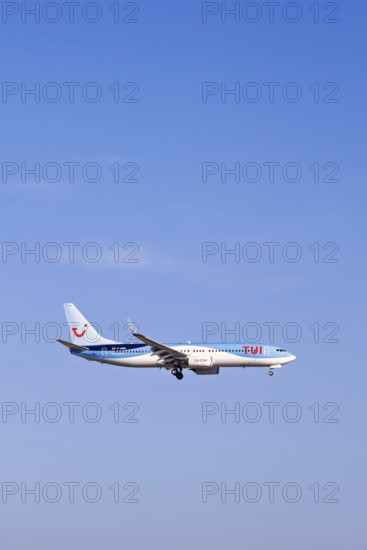 Passenger plane from Tui travel company flying on a blue sky, Mallorca, Spain