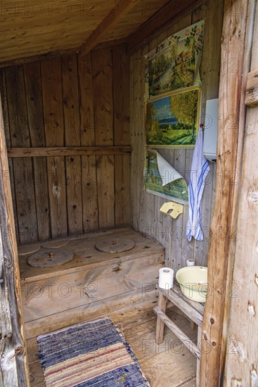 Interior of an old idyllic wooden outhouse for two in the swedish countryside, Sweden