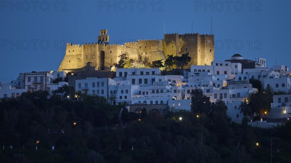 Illuminated castle high above white houses at night, Monastery of St John the Theologian, Monastery of St John the Theologian, World Heritage Site 1999, Chora, Patmos, Dodecanese, Greek Islands, Greece