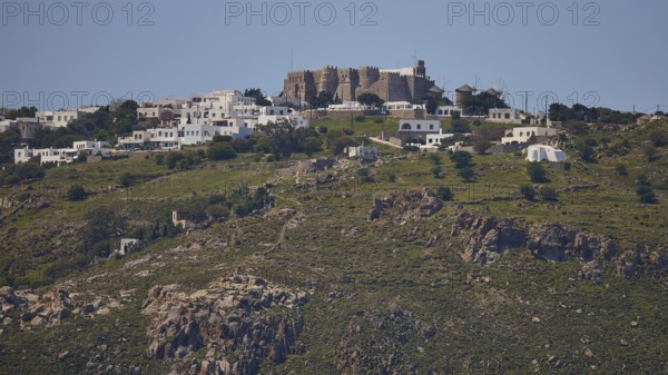 Village on a hill with stone houses and green landscape under a clear sky, Monastery of St John the Theologian, Monastery of St John the Theologian, World Heritage Site 1999, Chora, Patmos, Dodecanese, Greek Islands, Greece