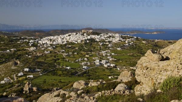 View of a village and green pastures with a distant coastline, Monastery of St John the Theologian, Monastery of St John the Theologian, World Heritage Site 1999, Chora, Patmos, Dodecanese, Greek Islands, Greece