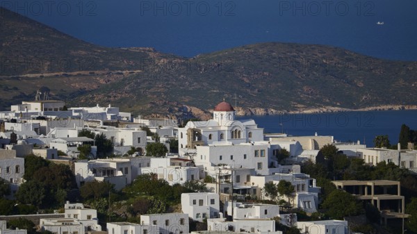 Whitewashed church with red roof in front of a coastal landscape and blue sea, World Heritage Site 1999, Chora, Patmos, Dodecanese, Greek Islands, Greece