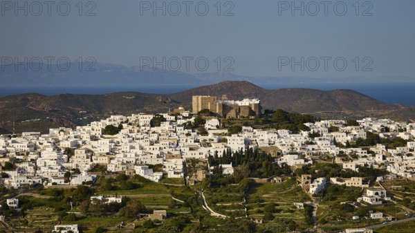 White houses against a mountainous backdrop with sea views, Monastery of St John the Theologian, Monastery of St John the Theologian, World Heritage Site 1999, Chora, Patmos, Dodecanese, Greek Islands, Greece