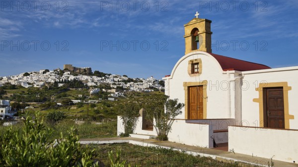 White chapel with a view of a village under a blue sky, chapel south of the Chora, World Heritage Site 1999, Chora, Patmos, Dodecanese, Greek Islands, Greece