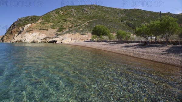 Quiet beach with green hill in the background and clear blue water, Lambi Beach, Lambi Bay, Patmos, Dodecanese, Greek Islands, Greece