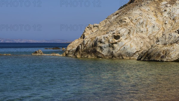 Rocky coast with calm, clear water under a blue sky, Lambi Beach, Lambi Bay, Patmos, Dodecanese, Greek Islands, Greece